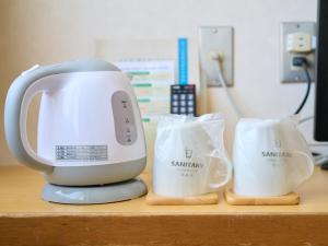 a white mixer sitting on top of a counter at Hotel Sincerity kani in Kani