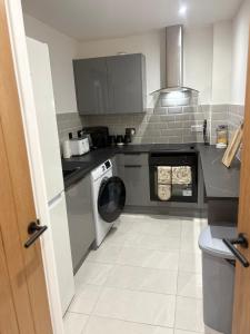 a kitchen with a washing machine and a washer at Olivers retreat in Braintree