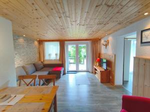 a living room with a couch and a table at Landhaus Danita in Bodensdorf