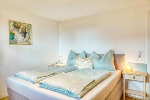 a bed with two pillows on it in a bedroom at Ferienwohnung Familiengarten in Volders