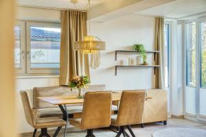 a dining room with a table and chairs at Ferienwohnung Familiengarten in Volders +14 photos