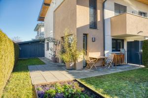 a patio with a table and chairs in a yard at Ferienwohnung Familiengarten in Volders