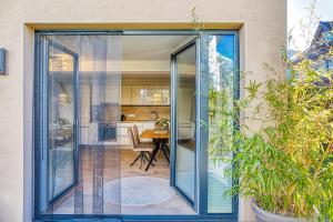 a sliding glass door leading to a dining room and kitchen at Ferienwohnung Familiengarten in Volders