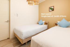 two beds in a small room with at Katan A in Yamada