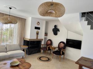 a living room with a couch and a fireplace at Eos in Çeşme