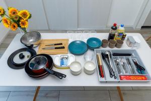 a table with utensils and a vase of flowers on it at Katan A in Yamada
