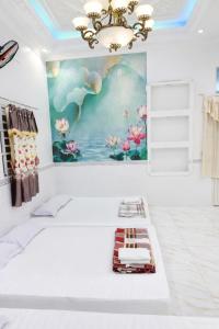 a room with a bed and a painting on the wall at Sao Mai Hotel Can Tho in Can Tho +44 photos