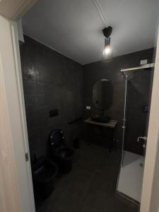 a bathroom with a toilet and a sink and a shower at Rooms 78 in Castel di Sangro
