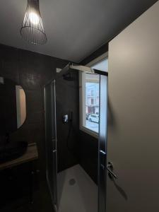 a bathroom with a shower with a sink and a window at Rooms 78 in Castel di Sangro