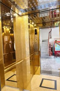 a glass door in a room with a staircase at Sao Mai Hotel Can Tho in Can Tho