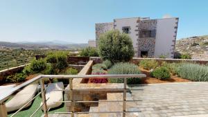 a view of a garden with a building in the background at Charlise Luxury Villa by Cretevasion in Anópolis +70 photos