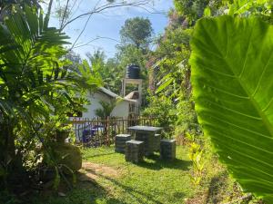 a garden with a table and benches in the yard at Samson's Home in Hiriketiya