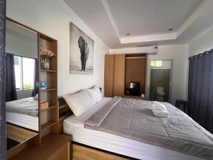 a bedroom with a large bed in a room at The Green Resort in Ko Chang