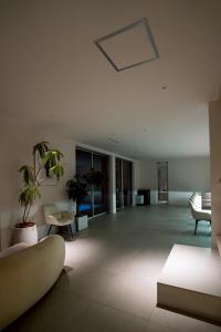 a large living room with a couch and chairs at Amatera in Kami Amakusa