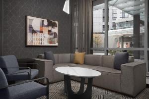 a living room with a couch and chairs and a table at Homewood Suites by Hilton Washington DC NoMa Union Station in Washington, D.C.