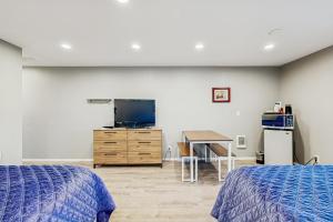 a bedroom with two beds and a tv and a desk at Sea Treasures Inn #210 in Rockaway Beach