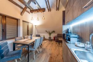 a dining room with a table and chairs and a kitchen at DIM Studio in Braşov
