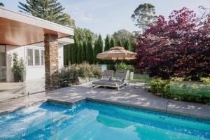 a swimming pool in the backyard of a house at Modern Luxuries Guesthouse in Berowra