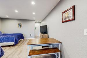 a bedroom with a bed and a tv in a room at Sea Treasures Inn #210 in Rockaway Beach
