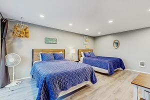 a bedroom with two beds with blue comforter at Sea Treasures Inn #210 in Rockaway Beach