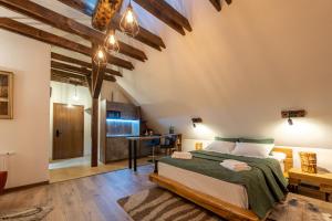 a bedroom with a large bed and a kitchen at DIM Studio in Braşov