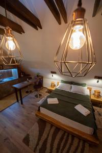 a bedroom with a large bed with two lights at DIM Studio in Braşov +56 photos