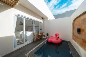 a room with a swimming pool and a bedroom at Ayodhya Villa Utari - North Wings in Yogyakarta
