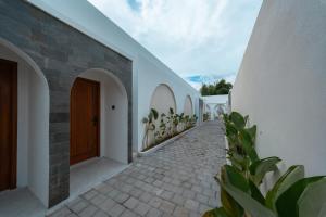 a hallway of a house with a wooden door at Ayodhya Villa Utari - North Wings in Yogyakarta