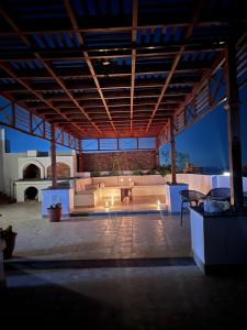 a large patio with a couch and a table at Spacious Luxury Nile-View Apartment on Upper Floor with Rooftop, Jacuzzi & BBQ ,Steps from Hilton Hotel in Luxor