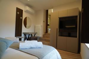 a bedroom with a bed with a flat screen tv at Mille Mt Suites - Cercemaggiore in Cercemaggiore