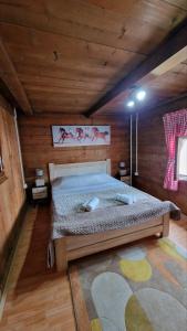 a bedroom with a bed in a wooden cabin at Vikendica Vlahović in Kolašin +26 photos