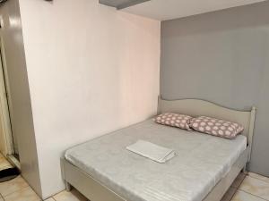 a small bed with two pillows on it in a room at Capitol Tourist Inn 2026 in Cebu City +1 photo