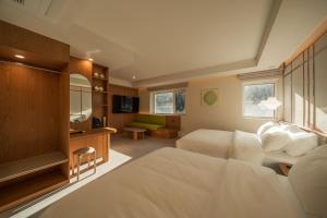 a hotel room with a bed and a living room at 신북 온심재 in Sajŏng-dong