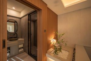 a bathroom with a sink and a mirror at 신북 온심재 in Sajŏng-dong