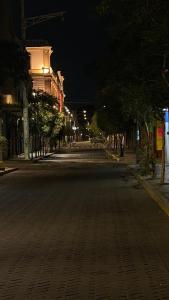 an empty street at night with trees and buildings at Ohmen House in Guadalajara
