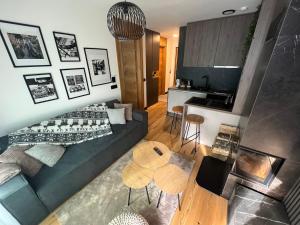 a living room with a couch and a table at Ski & Spa Bjelašnica in Bjelašnica