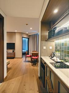 a kitchen and living room with a table and chairs at Mandala Sands Mũi Né in Phan Thiet