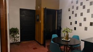 a dining room with a table and blue chairs at Ohmen House in Guadalajara +18 photos
