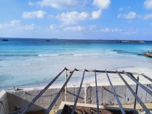 a sandy beach with the ocean in the background at On the Beach Villa Apartment in Alexandria