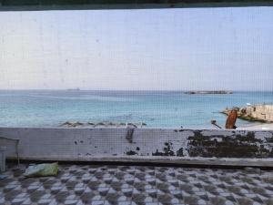a view of the ocean from a balcony at On the Beach Villa Apartment in Alexandria