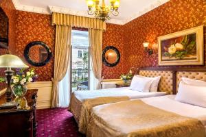 a hotel room with two beds and a window at Frederic Koklen Boutique Hotel in Odesa