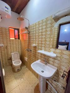 a bathroom with a sink and a toilet at NGK Hôtel Apartment in Bafoussam +87 photos