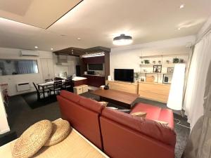 a living room with a couch and a table at Stay923 in Asahikawa