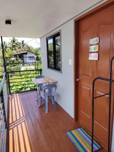 a room with a porch with a table and a door at EL3 Z'sPLACE HOSTEL in San Vicente