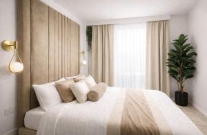 a bedroom with a white bed with pillows and a window at Astral Court Premium Accomodation in Ruislip +4 photos