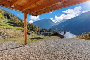 a view from the porch of a house with mountains in the background at Panoramic Alpine Garden Retreat in Vissoie