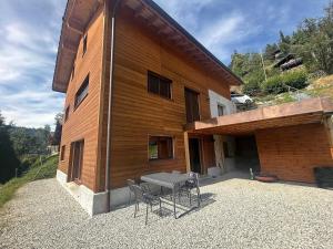 a patio with a table and chairs next to a building at Panoramic Alpine Garden Retreat in Vissoie +16 photos