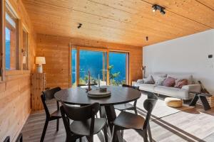 a living room with a table and chairs and a couch at Panoramic Alpine Garden Retreat in Vissoie