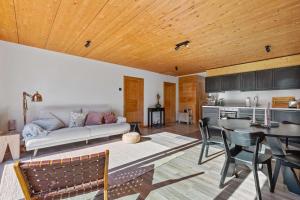 a living room with a couch and a table at Panoramic Alpine Garden Retreat in Vissoie