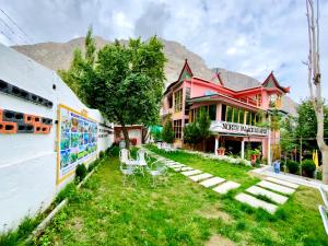a building with tables and chairs in front of it at North Palace Khaplu in Khaplu